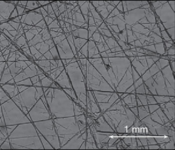 Microscopic example of edge rounding on a nitrided steel sample.